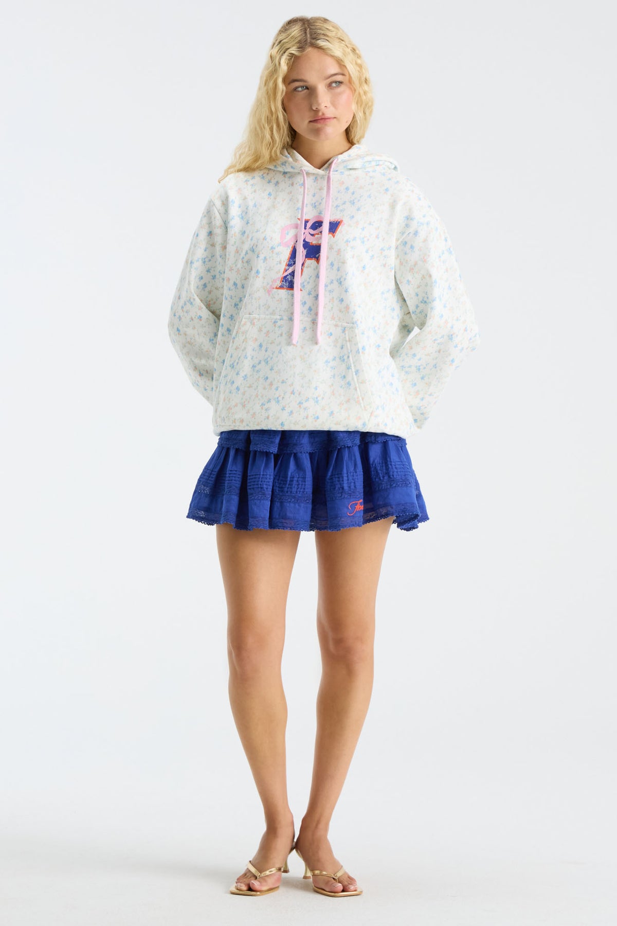 Blue ruffle mini skirt with layered tiers and scalloped lace hem.