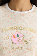 Light blue graphic ringer tee detail with Hurricanes text and helmet patch