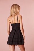 Black cotton mini dress back view with spaghetti straps and lace-trim neckline
