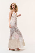 Pale pink crochet maxi dress with patchwork circles and openwork lace paneling.