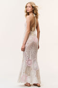 Pale pink crochet maxi dress, side view, openwork pattern with thin adjustable straps.