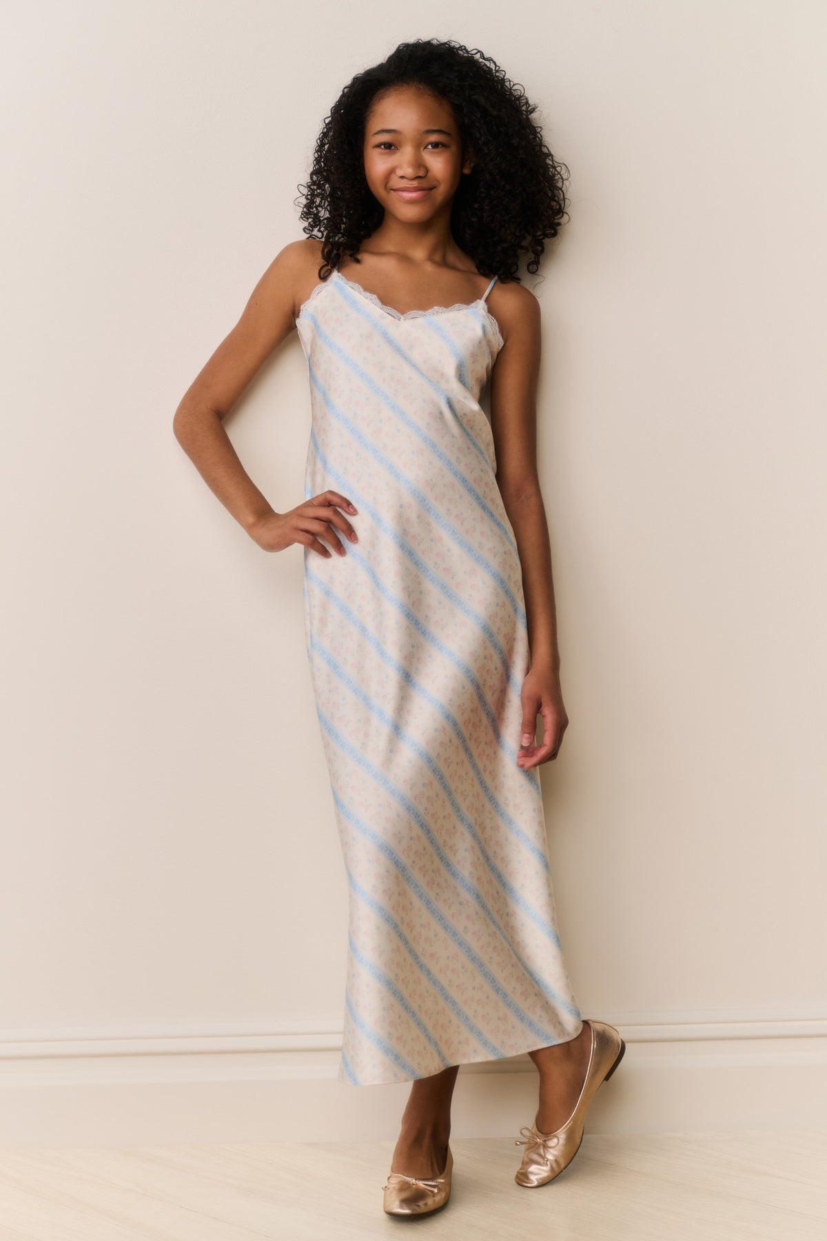 Light blue and white striped sleeveless maxi dress with spaghetti straps and fitted bodice