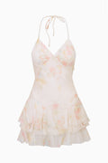 White silk chiffon mini dress with pastel print, V halter, and layered ruffle skirt
