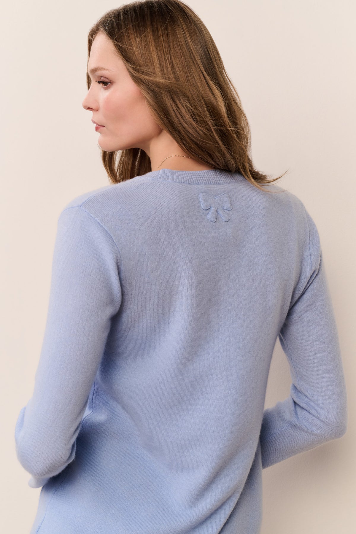 Light blue cashmere cardigan back with long sleeves and small embroidered motif