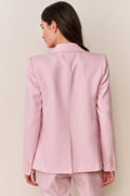 Back view of pink blazer with long sleeves and structured seams