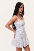 Light blue printed mini dress with smocked waist and tiered ruffle skirt, lace-trim straps.