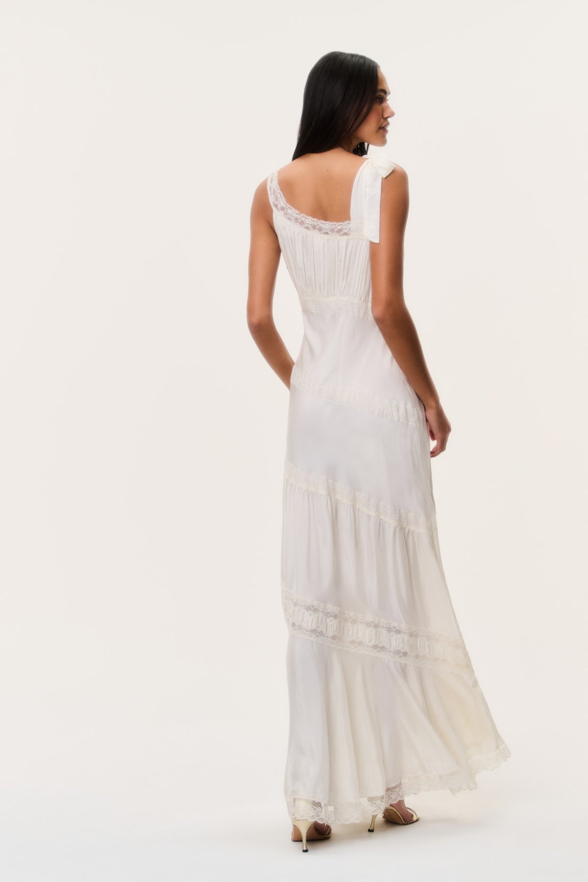 Ivory sleeveless maxi dress with lace trim, open back tie, and tiered skirt