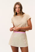 Active skort front view with pale micro-print and pink piping along hem