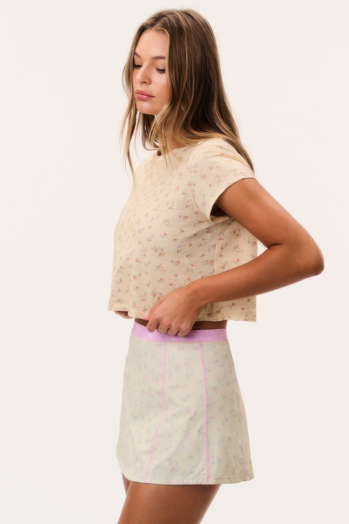 Active skort with pale pattern and pink-trim waistband; short pleated skirt