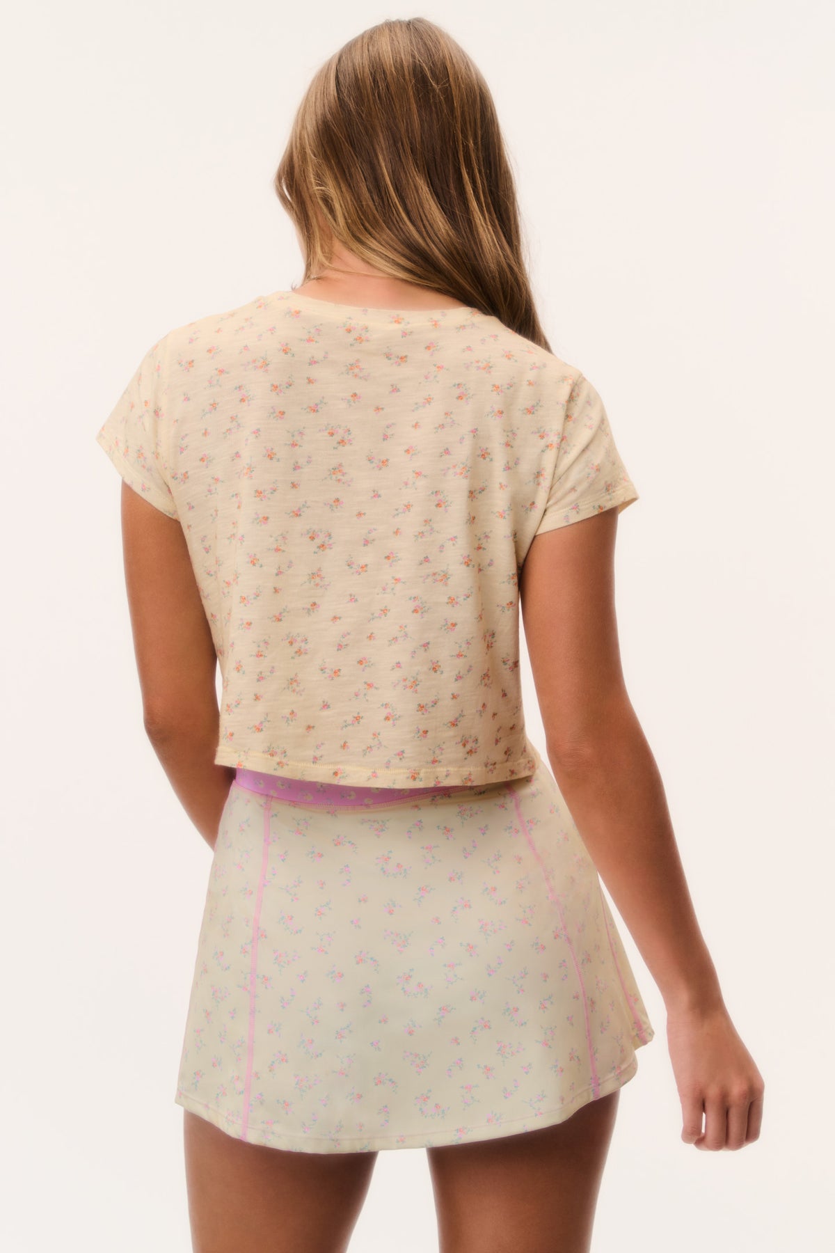 Active skort back view, pale printed fabric with pink piping