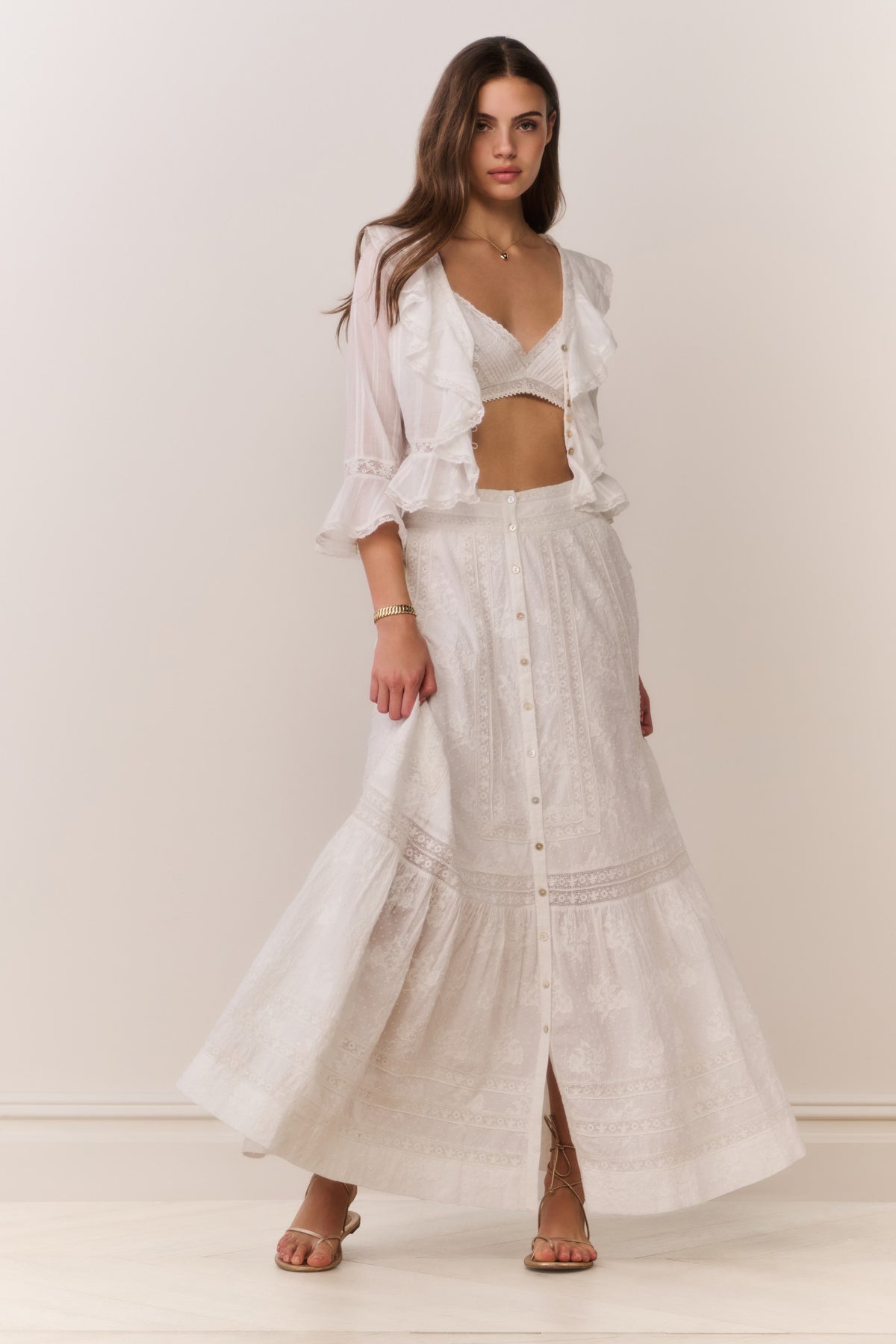 White maxi skirt with button front, tiered ruffle hem, embroidered texture