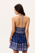 Back view of midnight blue cotton mini dress with open back and bandana print skirt