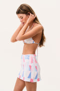 Swim skirt with patchwork print in white, blue, and pink, flared ruffle hem