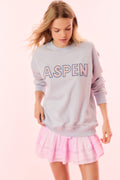 Light blue crewneck pullover sweatshirt with “ASPEN” logo graphic on front