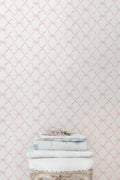 Bow-pattern wallpaper in faded primrose, showing pale bow lattice design