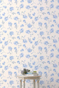 Floral wallpaper roll with light blue rose pattern on cream background