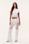Optic white patchwork lace flared pants with embroidered panels, high-rise fit