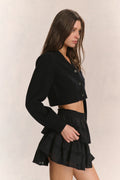 Black V-neck crop cardigan with button front and long ribbed sleeves (side view)