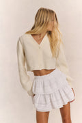 Ivory ribbed V-neck crop cardigan with button front and long sleeves (back view)