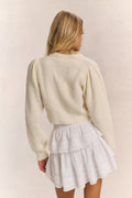 Ivory ribbed V-neck crop cardigan with button front and long sleeves (rear view)