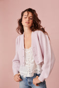 Light pink ribbed cropped V-neck cardigan with button front and long sleeves