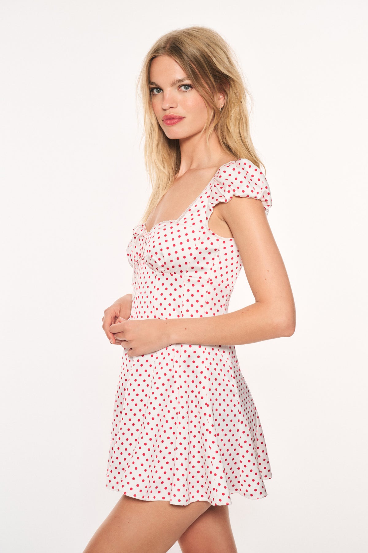 Pink polka-dot mini dress, sweetheart neckline, cap sleeves, ruffled hem