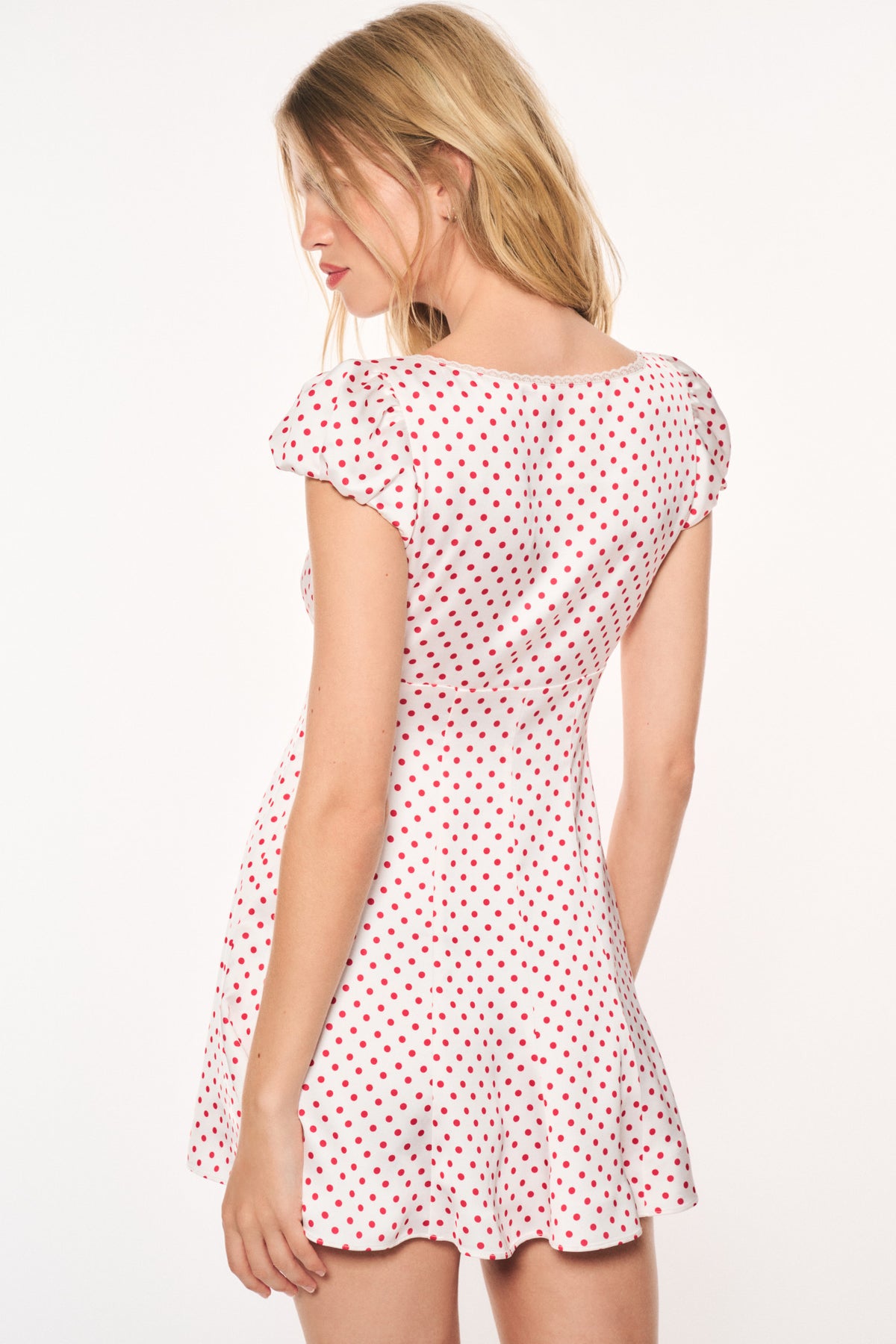 Pink polka-dot mini dress back view, cap sleeves, fitted bodice, ruffled hem