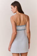 Light blue tweed mini dress with denim-trim straps, open back, bow detail