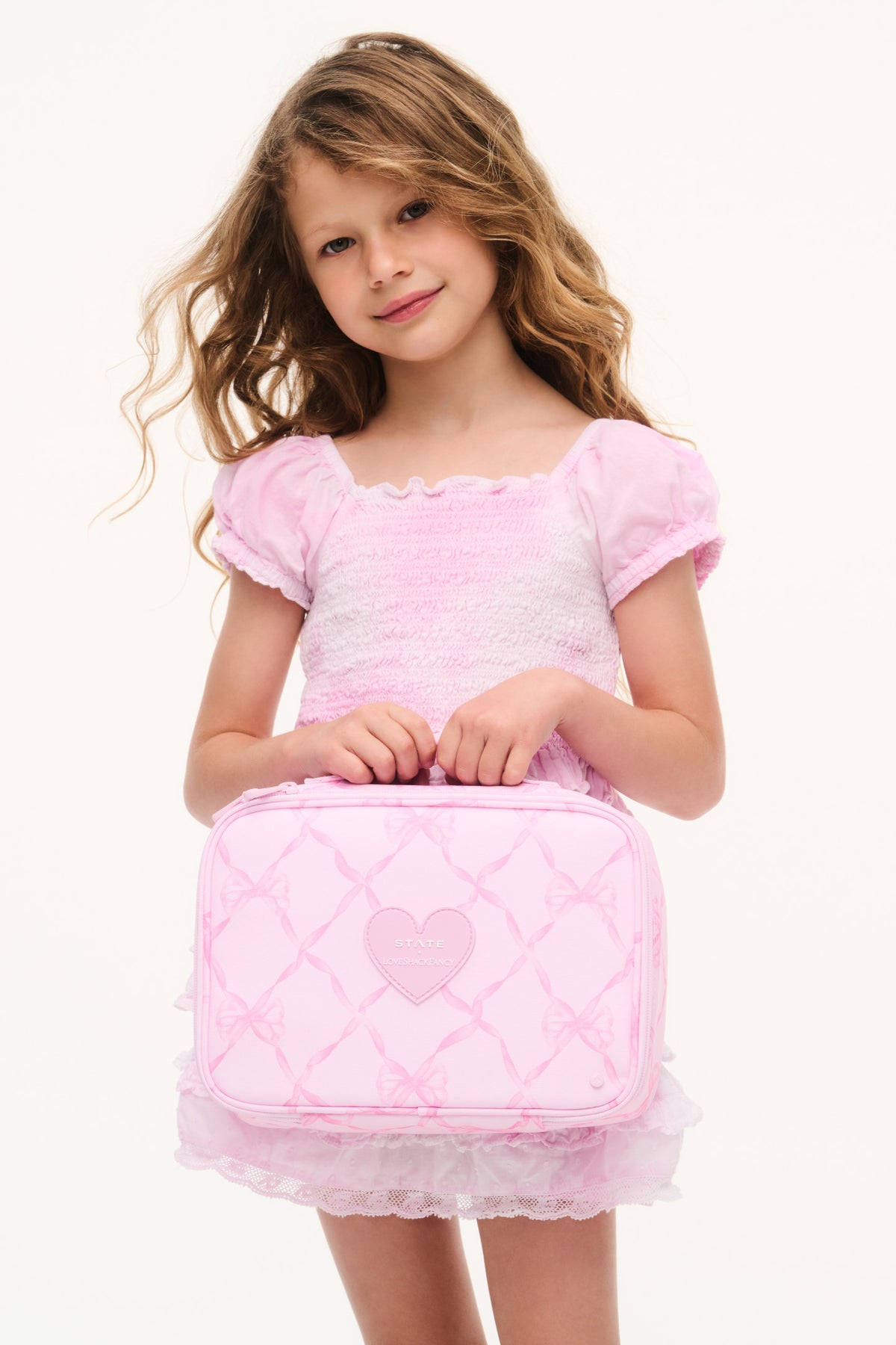 Pink zip lunch box with heart patch and crisscross pattern