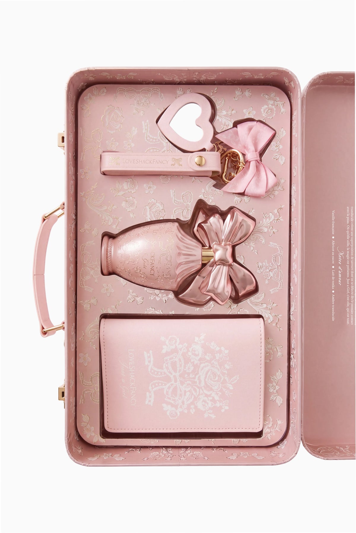 Blush travel fragrance set in open case with heart latch and ribbon bottle
