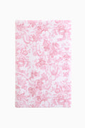 Cotton bath towel, pink with repeating floral bow pattern, plush terry surface.