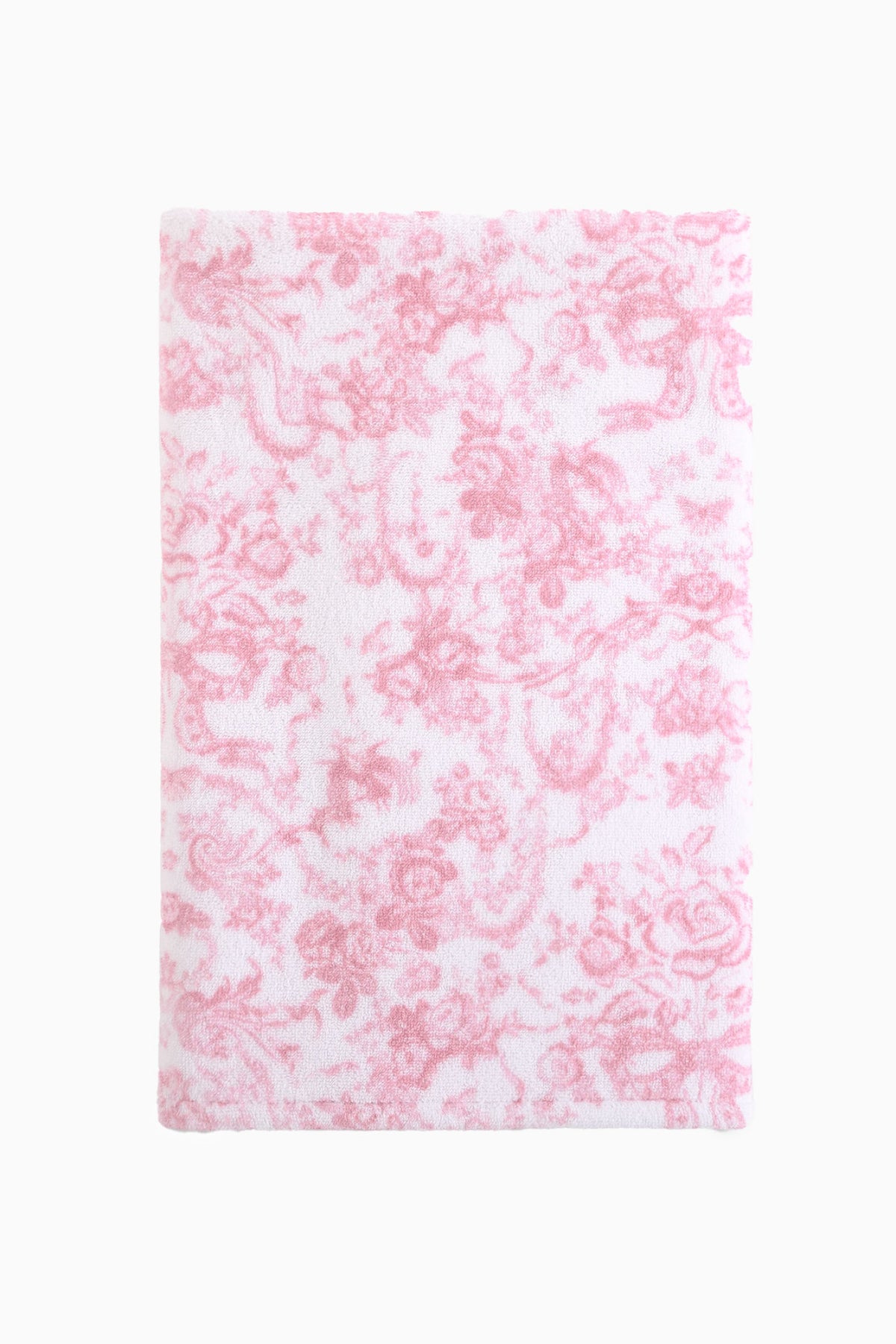 Cotton bath towel, pink with repeating floral bow pattern, plush terry surface.