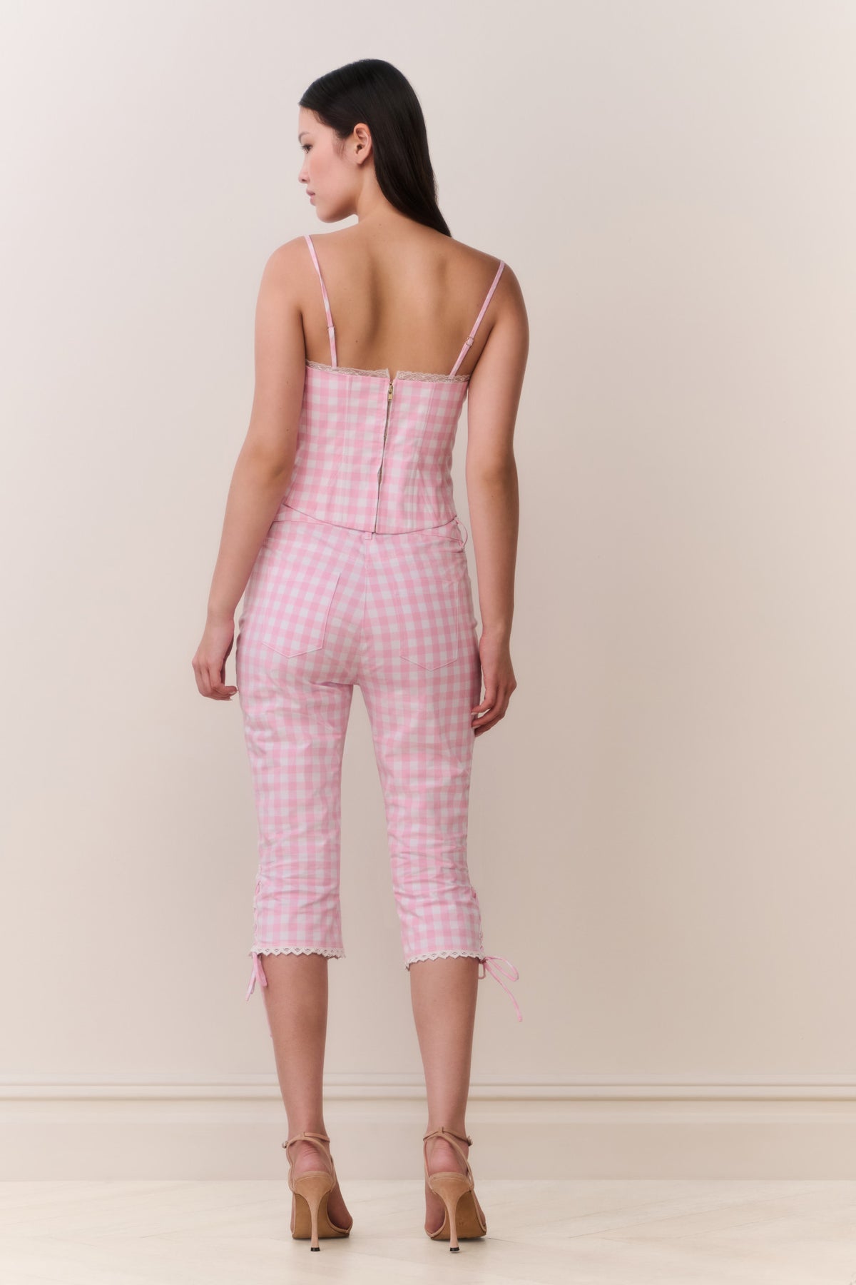 Pink gingham capri pants, rear view with lace-tie cuffs and cropped length