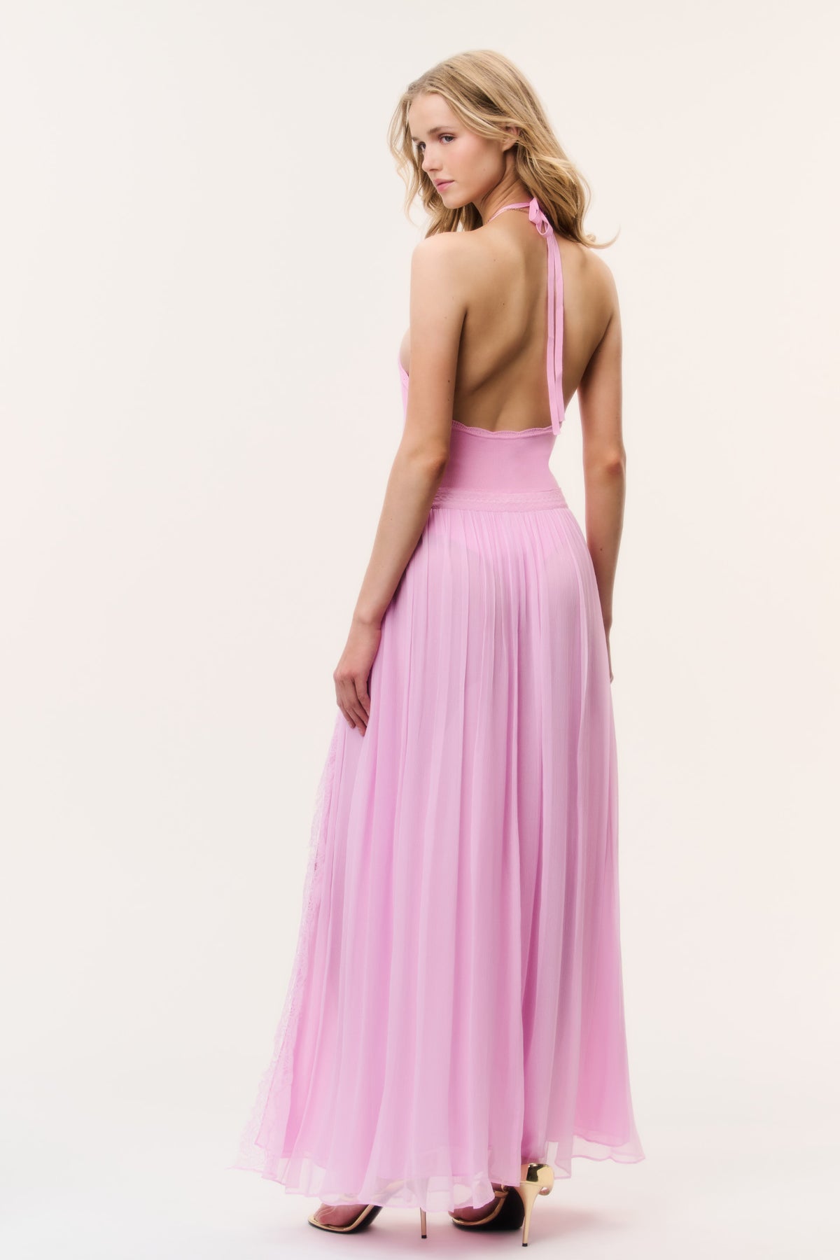 Pink back view of sheer maxi skirt with lace panel and high slit