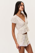 Floral short-sleeve blouse with lace-trim V-neck, puff sleeves, cinched waist
