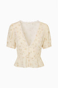 Cream floral short-sleeve blouse with V-neck lace trim and puff sleeves
