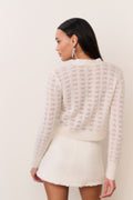 Cream tweed mini skirt with gold button front and textured fringe hem