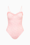 Peach-pink patterned one-piece swimsuit with thin straps and scalloped bust detail