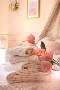 Cotton bath towel, light blue and white patterned folds with rose accent