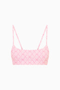 Pink sports bra with sweetheart neckline and thin straps, geometric grid print