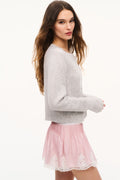Light gray cashmere cardigan shown in side view, long sleeves with button placket