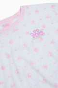 Close-up of light pink cotton tee with small bow pattern and โPINKโ emblem