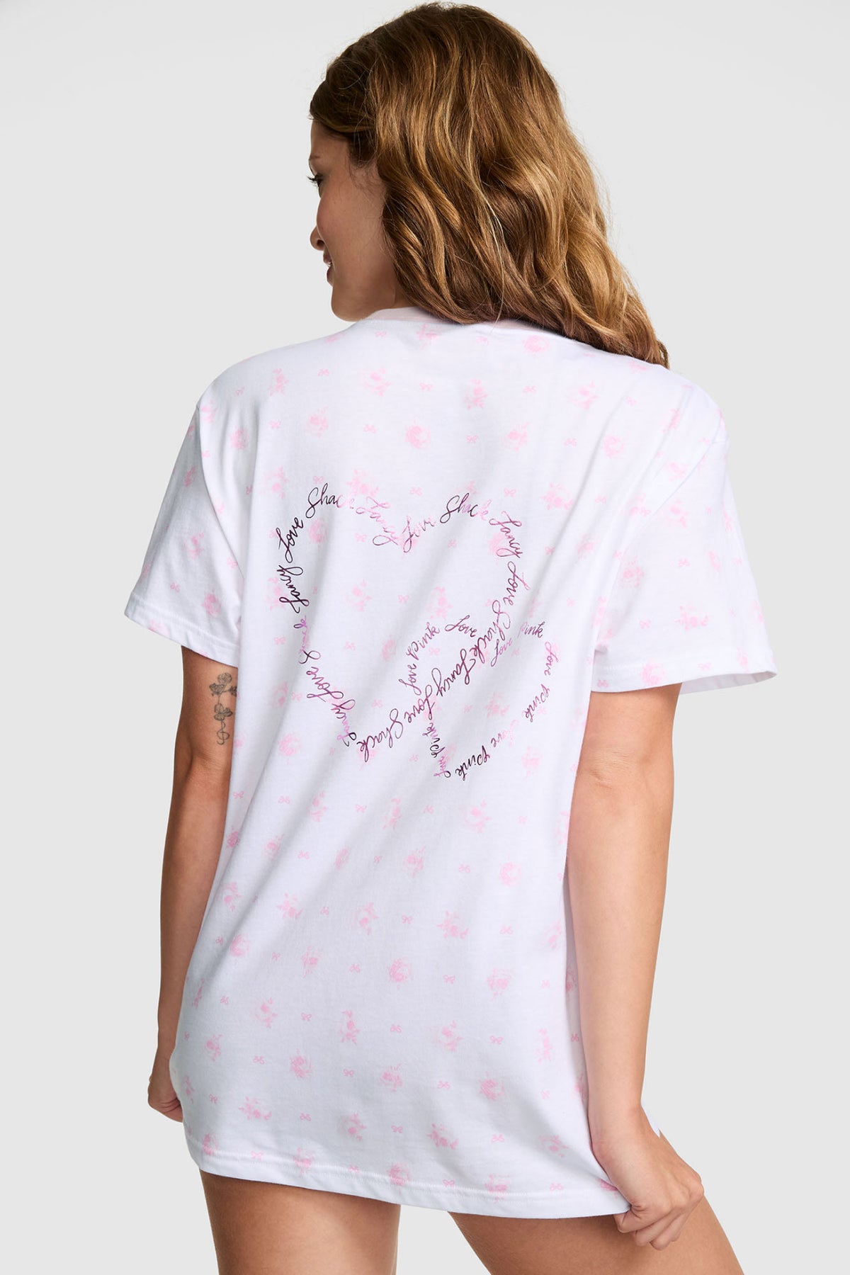 Pink cotton campus tee, back view with LoveShackFancy heart graphic detail