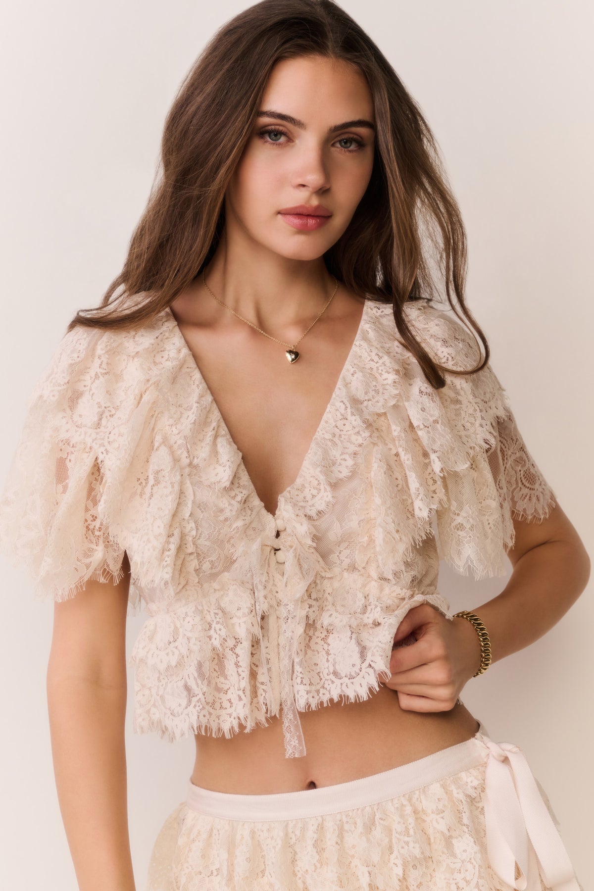 Ivory lace ruffle crop top with deep V-neck and layered lace details