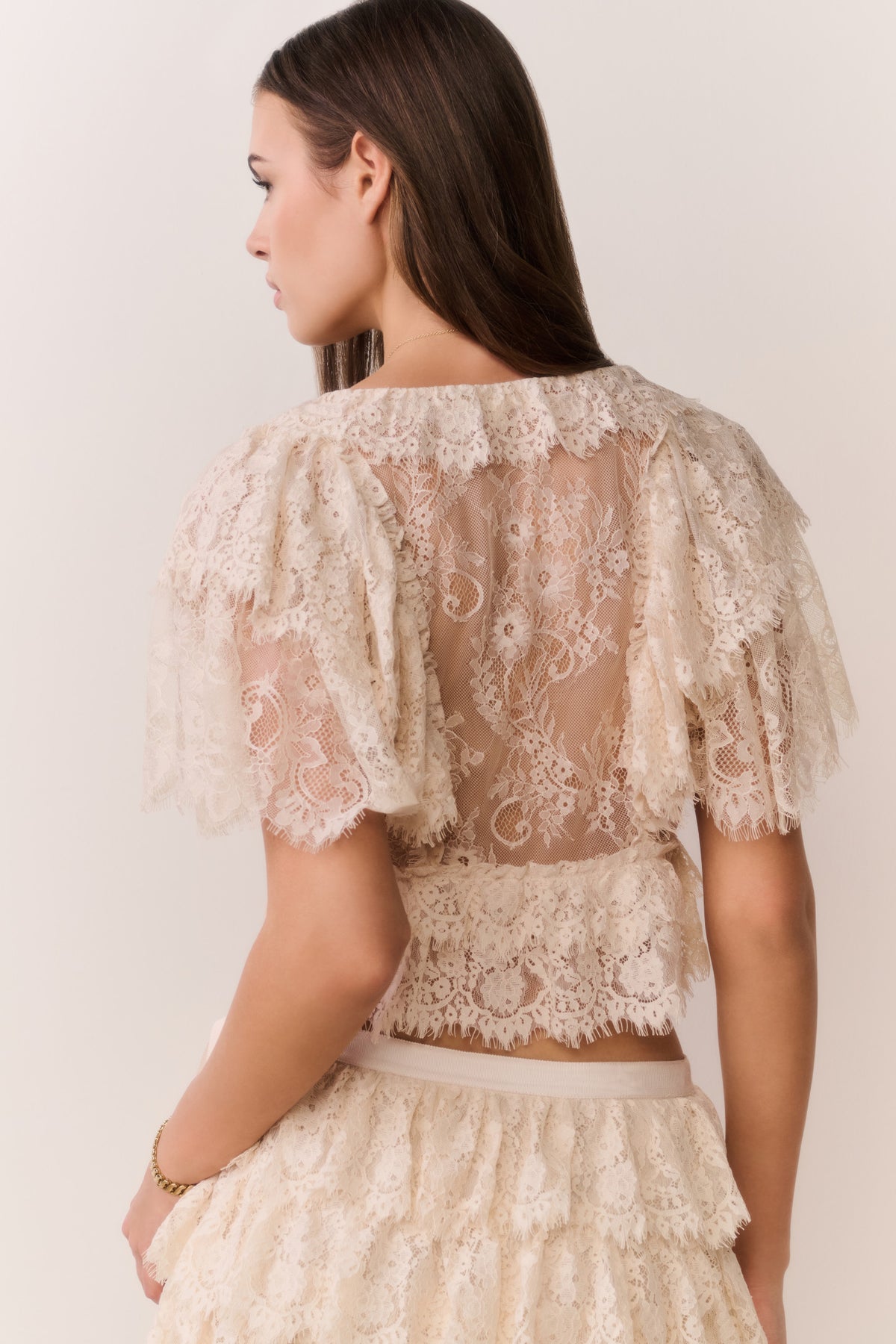 Ivory lace ruffle crop top from the back with lace flutter sleeves