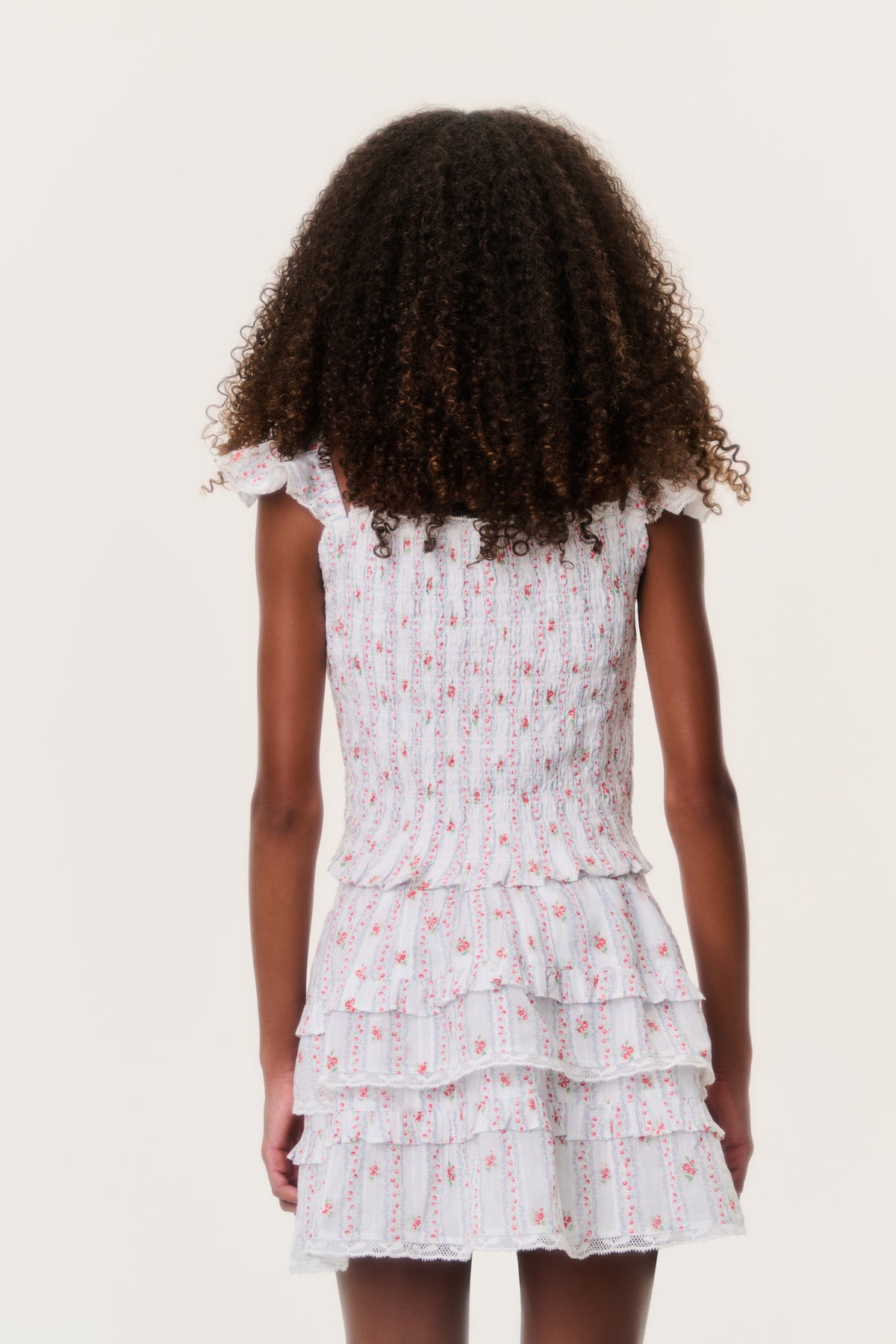 Back view of tiered ruffle tween skirt in white with red and pink stripe pattern
