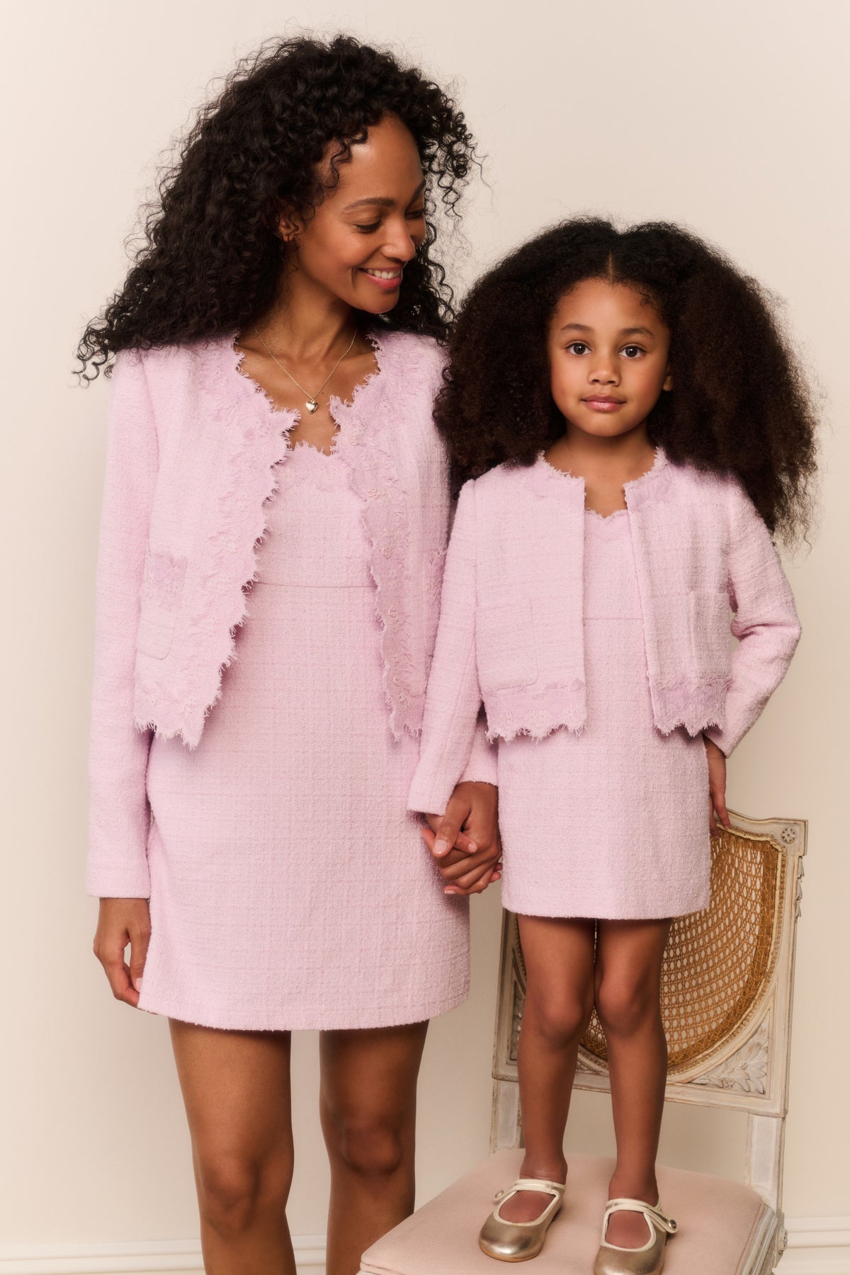 Pink lace-trimmed tweed jacket over a mini dress, front view