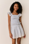 Ivory floral cotton skirt with tiered ruffles and lace-trim hem, three-quarter view