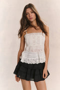Cotton cami top in bright white with lace trim, thin straps, and textured panels.
