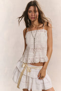 Cotton cami top in bright white with lace trim, vertical panel detailing, and thin straps.